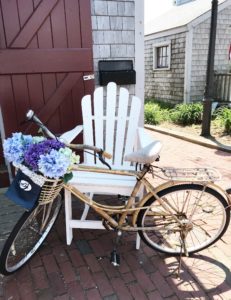 Nantucket Bicycle by chair at shop in Nantucket