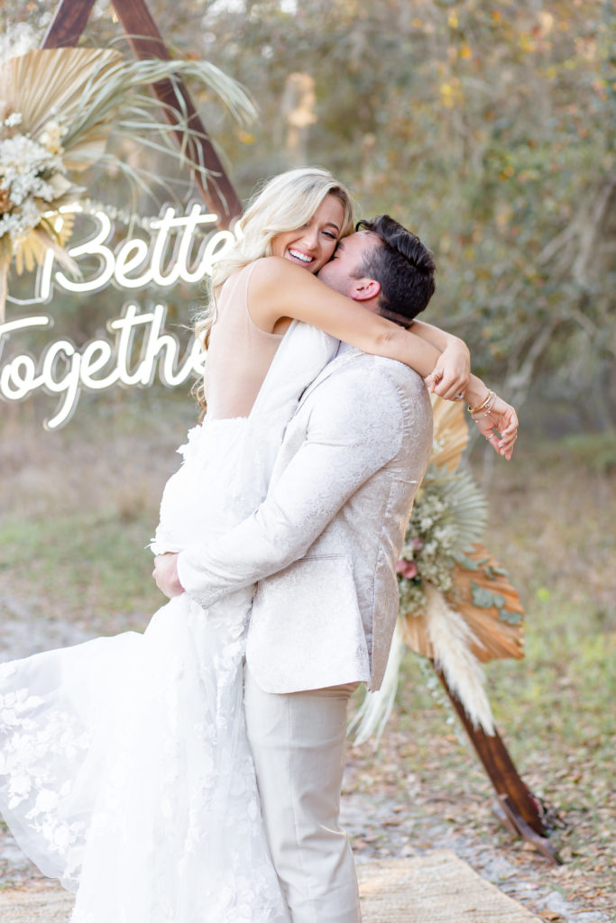 Adorable embrace between bride and groom at boho elopement