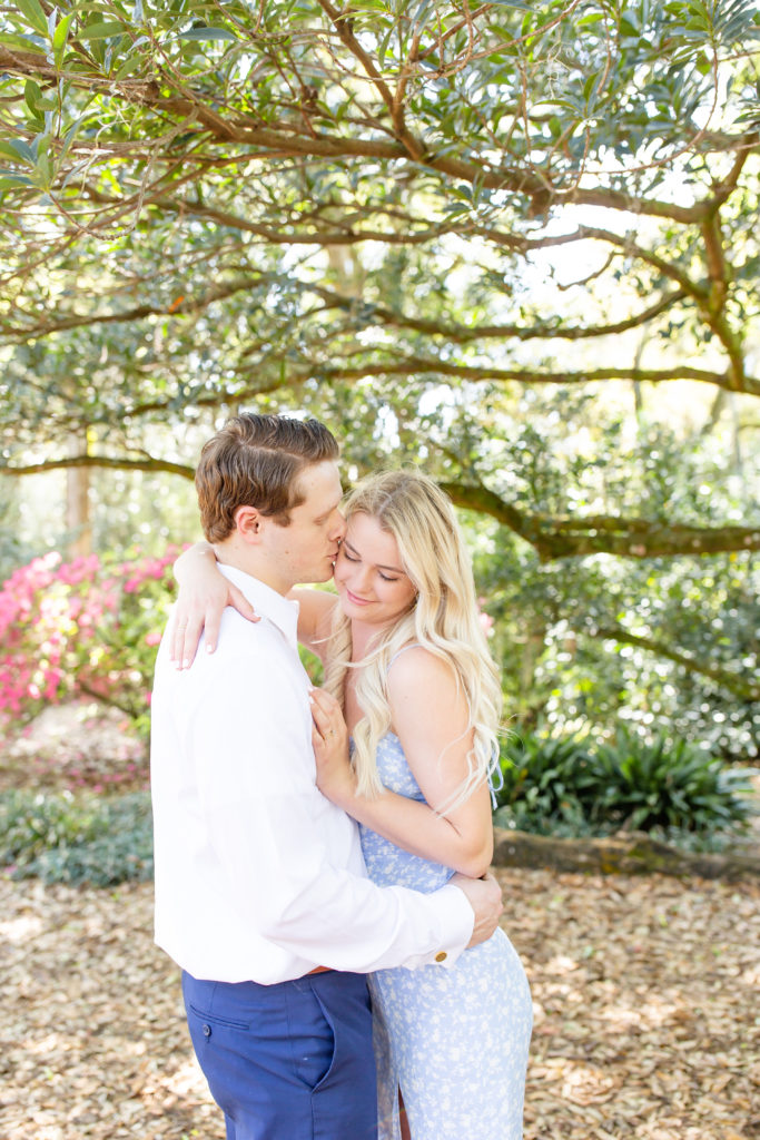 Bok Tower Gardens engagement photos underneath the trees with the couple kissing