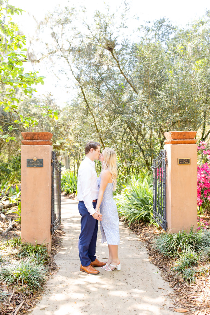Bok Tower Gardens engagement photos with the couple kissing, framed perfectly between two orange-beige columns