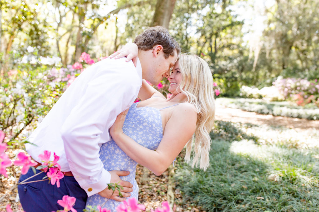 Bok Tower Gardens engagement photos with striking pink flowers surrounding the couple