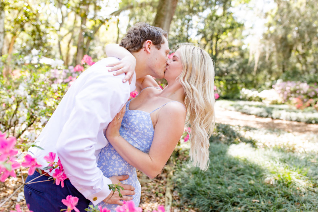 Bok Tower Gardens engagement photos with striking pink flowers surrounding the couple