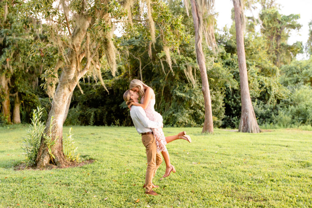 Engagement photos with the woman being lifted in the air