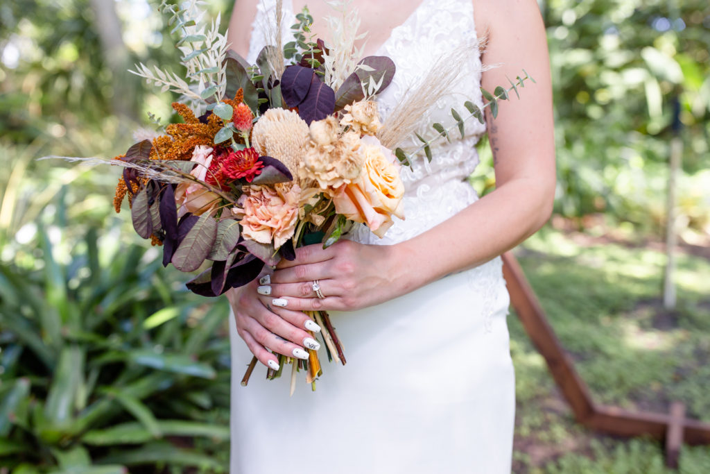 Mead Botanical Garden Wedding with the bride holding a boho fall bouquet