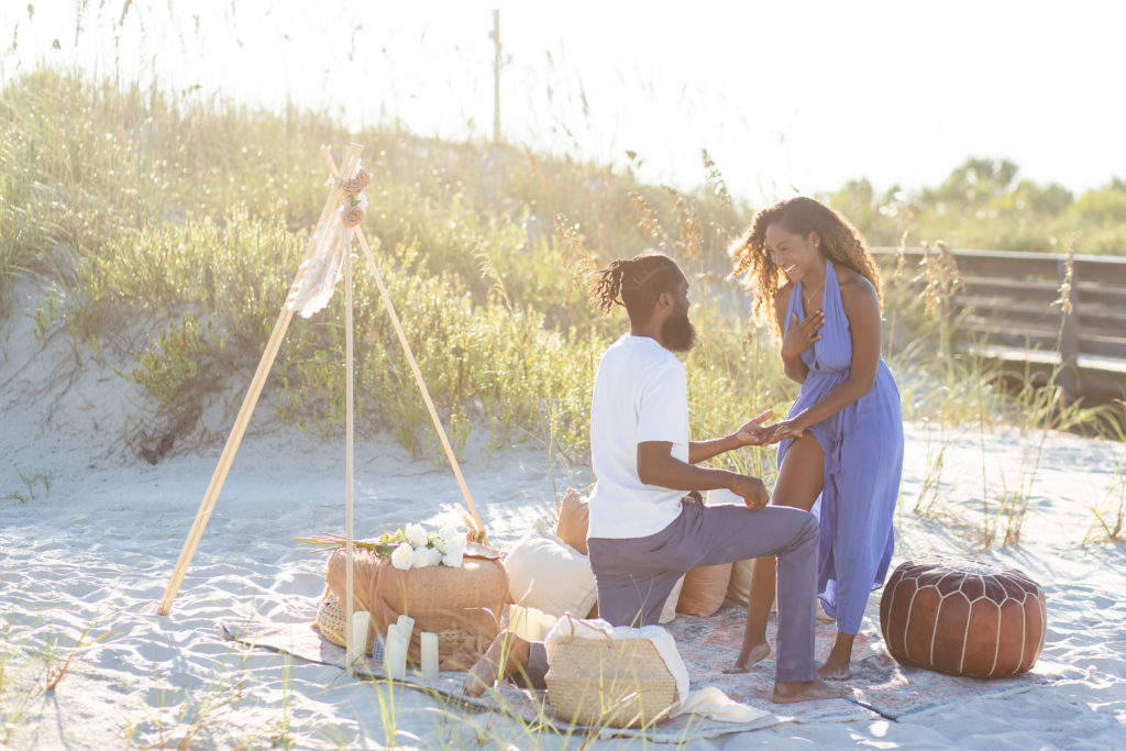 Beach proposal at New Smyrna Beach with a picnic and boho backdrop