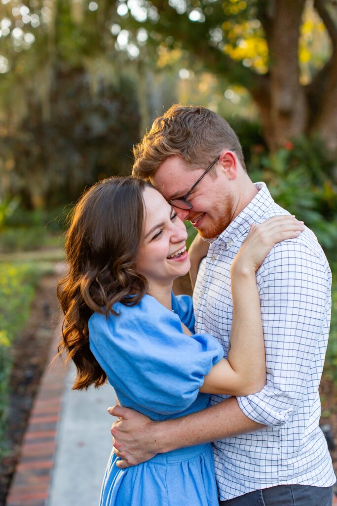 Couple laughs and hugs for their engagement photos at Cypress Grove Park in Orlando, Florida