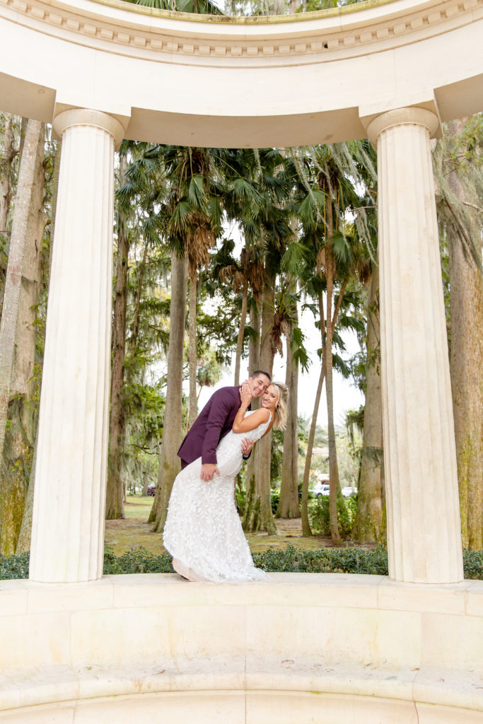 Kraft Azalea Garden Wedding Photo — Groom Dips Bride Under Gazebo
