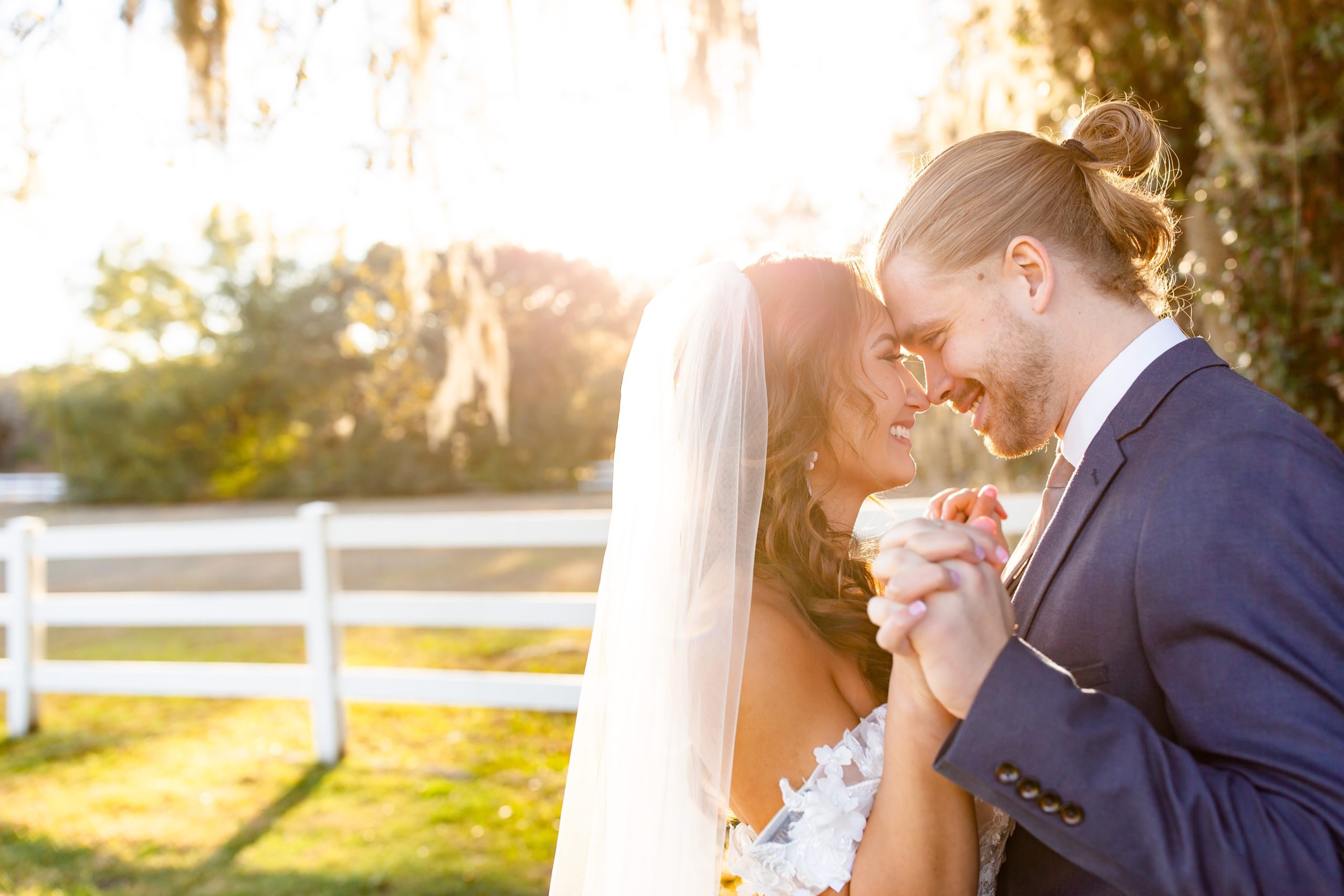 Bramble Tree Estate Wedding Photo — Bride and Groom sunset portraits holding hands under Spanish Moss