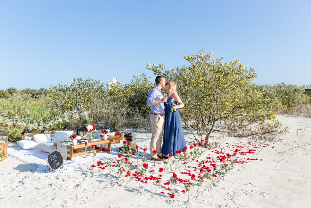Florida Beach Proposal Photos - New Smyrna Dunes Park Proposal — Surprise Beach proposal with pop up picnic and rose petals on the beach, Champagne Toast