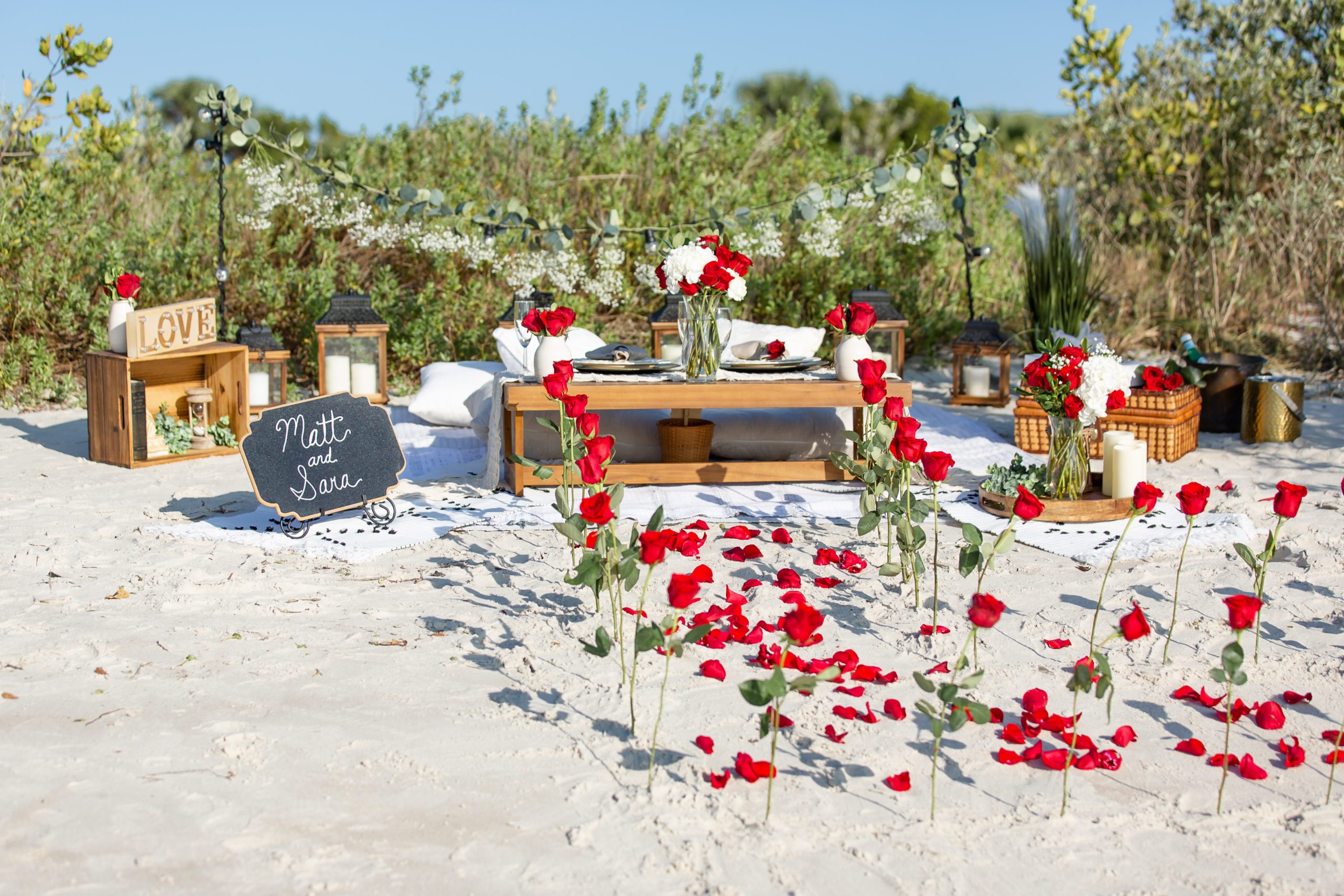 Rose petal aisle on the beach for a surprise proposal in Florida