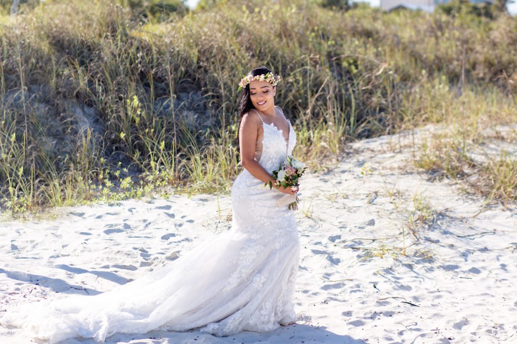 New Smyrna Beach Elopement Photo — Bride on the beach with bridal bouquet and flower crown