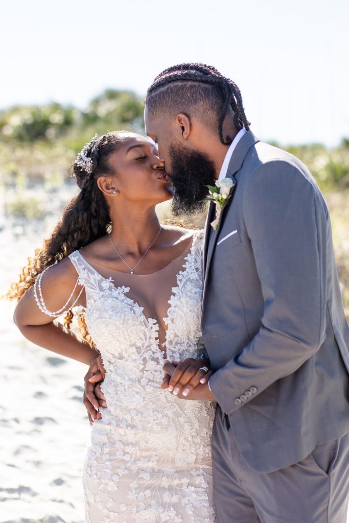 Florida beach wedding photo — couple kisses