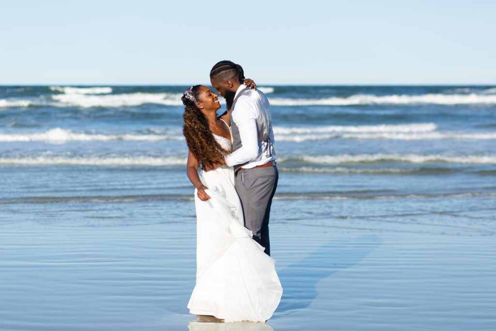 New Smyrna Beach Wedding Photo — Bride and Groom dancing on the beach