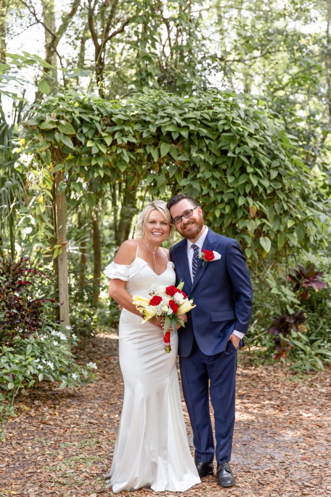 Mead Botanical Garden Elopement Wedding Photo — Bride and Groom standing under ivy arbor