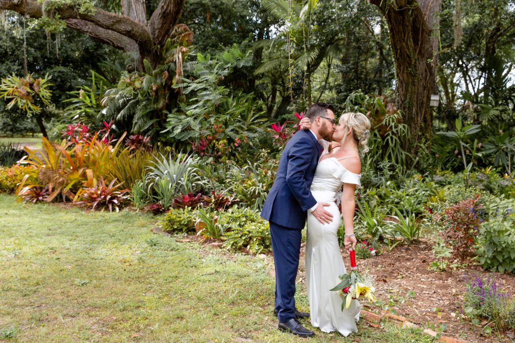 Mead Garden Wedding Photo — Bride and Groom kissing in the tropical garden