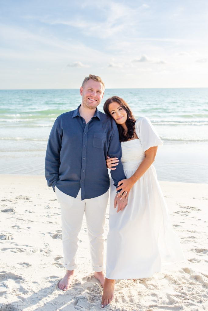 Florida engagement photos — Couple holding hands on the beach