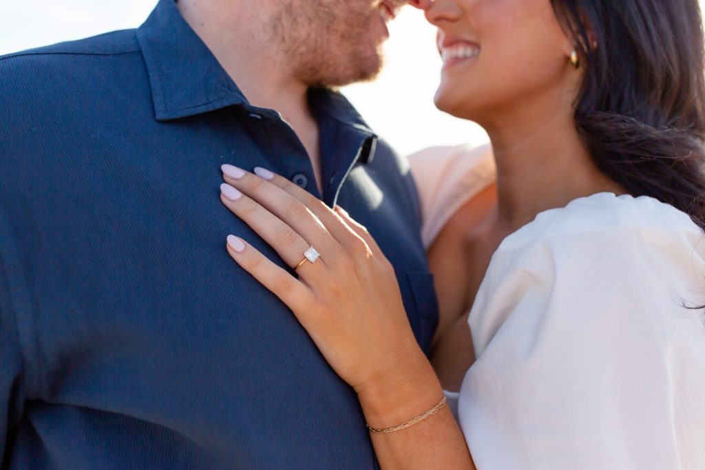 Close-up of an engaged couple with focus on the ring