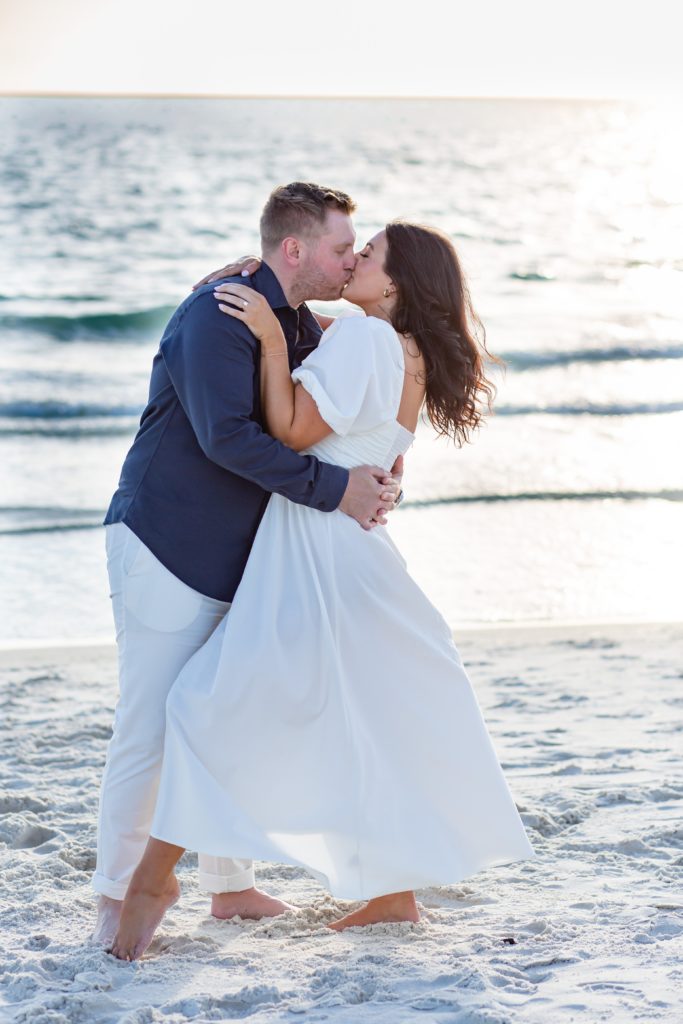 Couple kisses on the beach during their Florida engagement photo session
