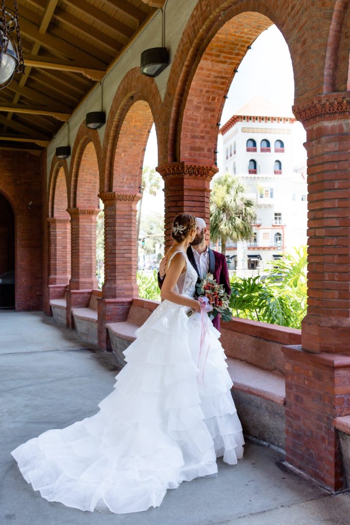 Flagler College Wedding Photo — Bride and Groom in front of St. Augustine backdrop
