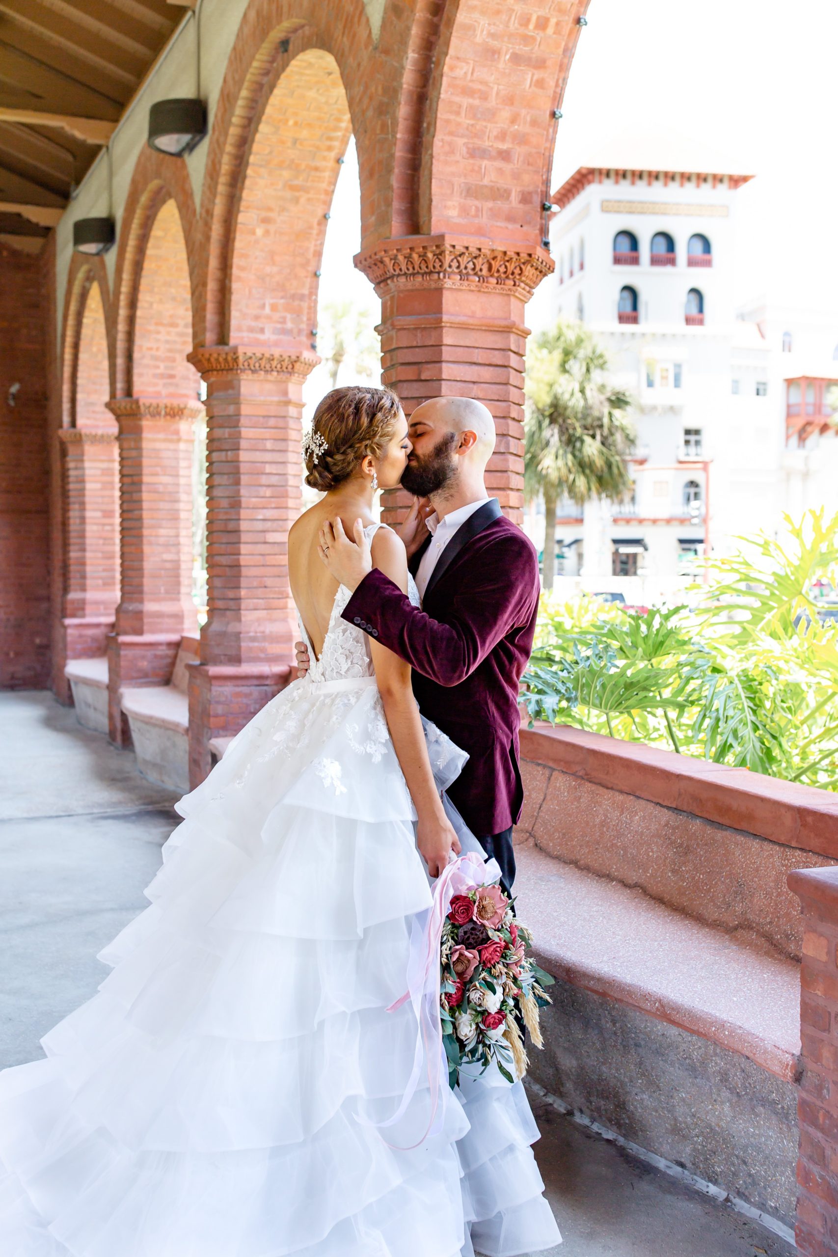 Flagler College Wedding Photo — Bride and Groom in front of St. Augustine backdrop