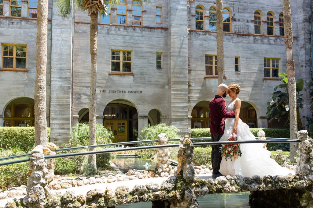 Lightner Museum Wedding Photo — Bride and Groom standing on bridge in courtyard