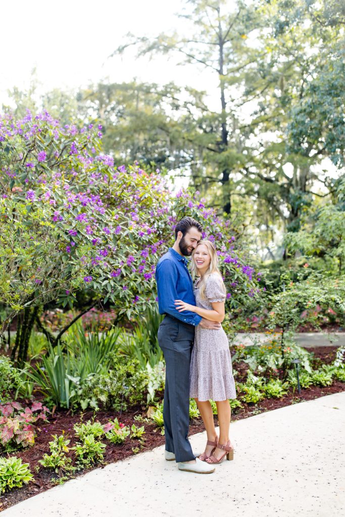 Leu Gardens Engagement Photos in Orlando, FL — Couple standing in front of tree with purple flowers