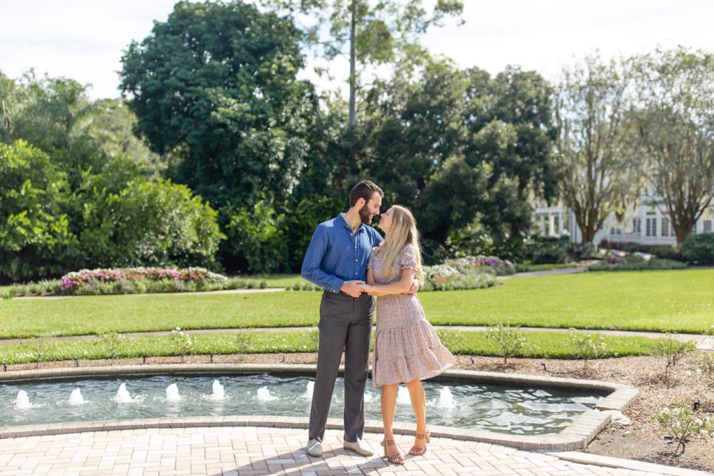 Leu Gardens Engagement Photos in Orlando, FL — Couple dancing in front of fountains