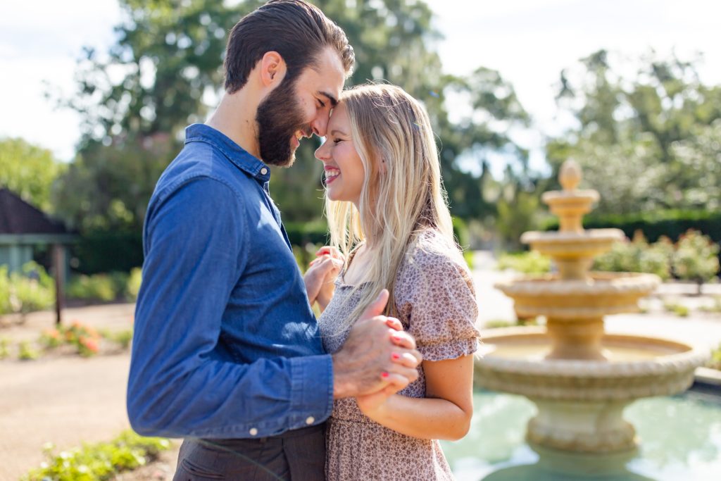 Leu Gardens Engagement Photos in Orlando, FL — Couple standing in front of fountain in rose garden