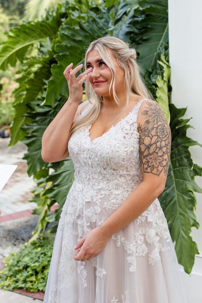 Leu Gardens Wedding Photos in Orlando, FL — Bride tearing up at wedding ceremony in idea garden