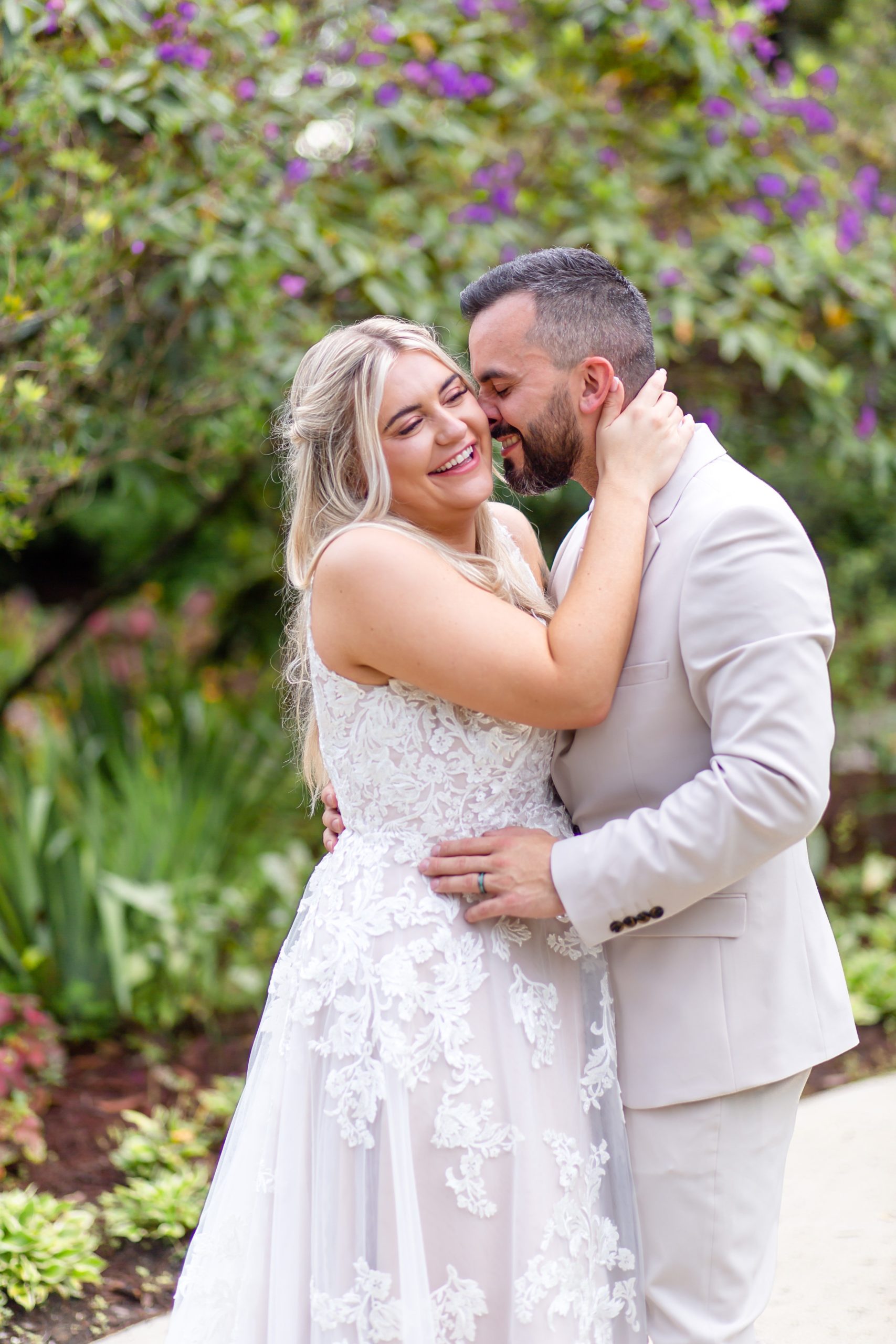 Leu Gardens Wedding Photos in Orlando, FL — Groom making Bride laugh in front of purple flowers