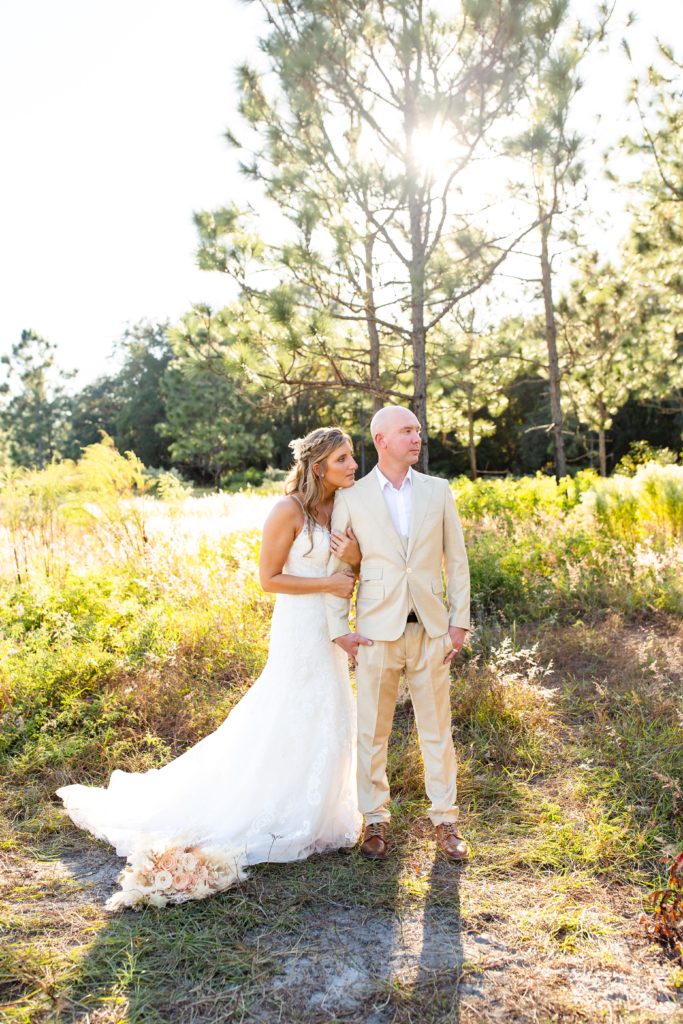 Lake Louisa Wedding Photos in Orlando, FL — Bride and Groom standing in field