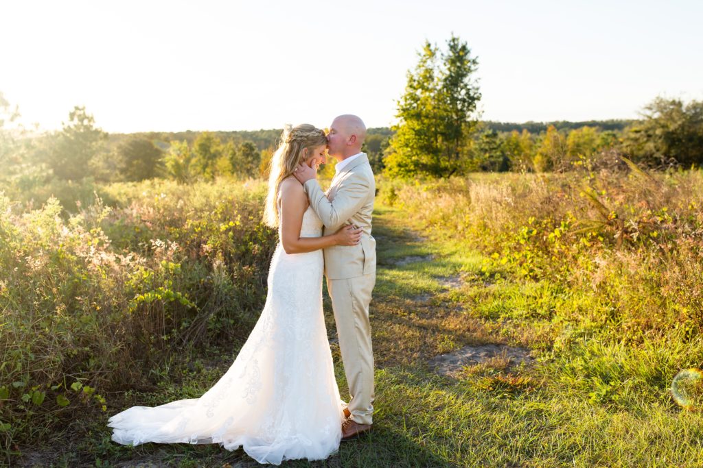 Lake Louisa Wedding Photos in Orlando, FL — Bride and Groom standing in field at sunset