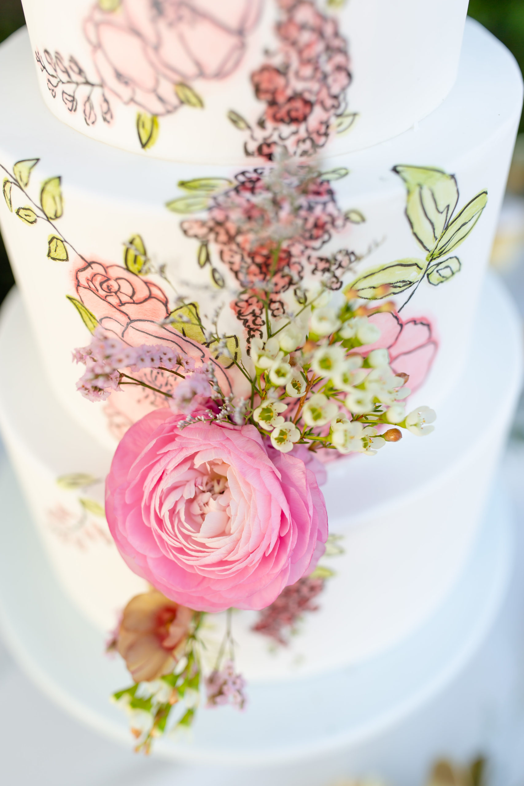 Two tier wedding cake with fresh pink and green florals