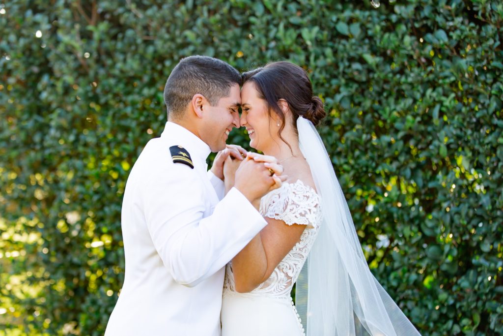 Bride and Groom holding hands forehead to forehead and laughing at Bramble Tree Estate in Orlando, Florida