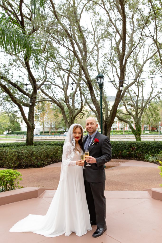 Bride and Groom with champagne toast after eloping at Disney Swan Resort in Orlando, FL