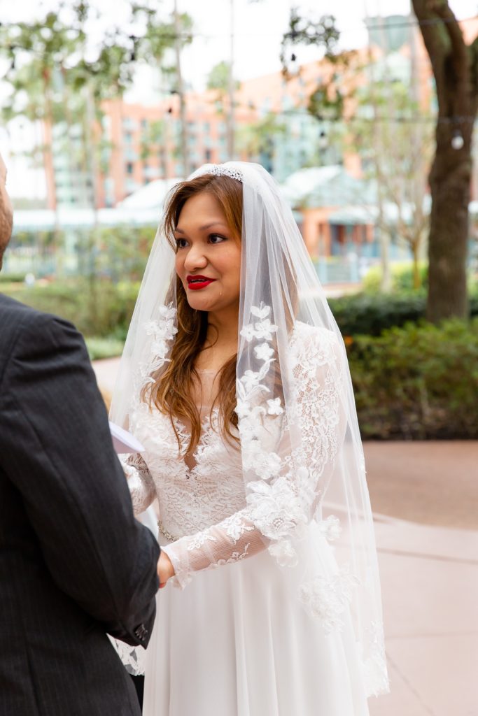 Bride saying Vows with beautiful veil at Disney Swan Resort in Orlando, FL