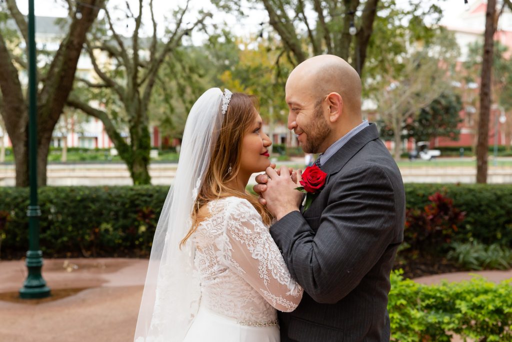 Bride and Groom looking at each other and holding hands after eloping at Disney Swan Resort in Orlando, FL