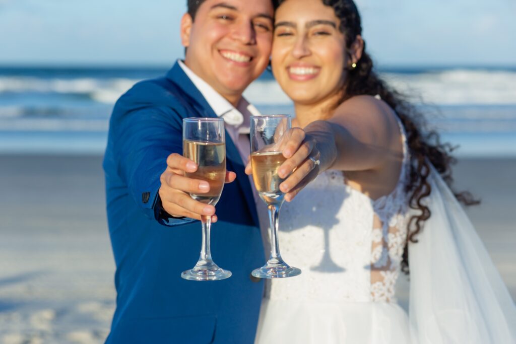 Bride and Groom toasting with champagne on the beach after their Florida beach wedding