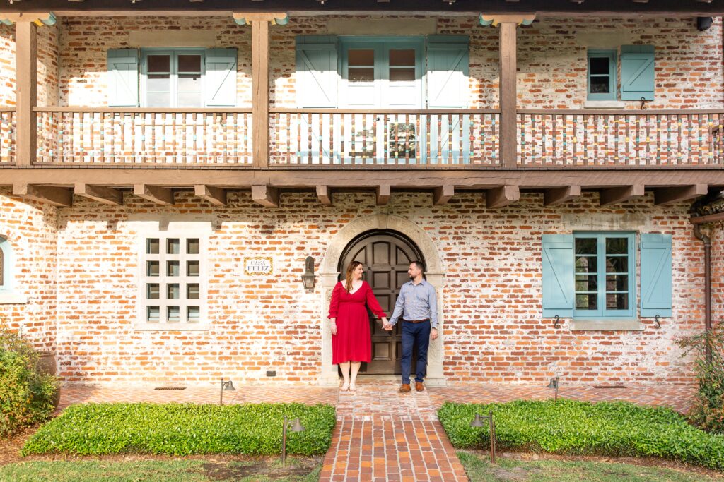Casa Feliz Historic Home Orlando Engagement Photos — Couple holding hands in front of Spanish historic home in Winter Park, Florida
