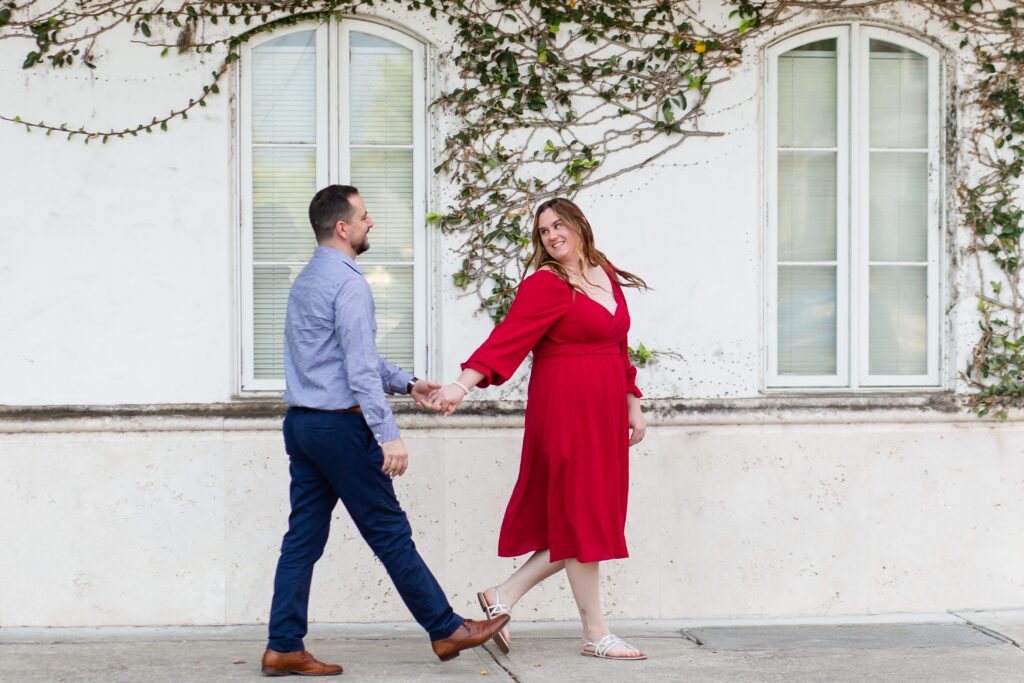 Hannibal Square Orlando Engagement Photos — Couple walking in front of Ivy Wall in Winter Park, Florida