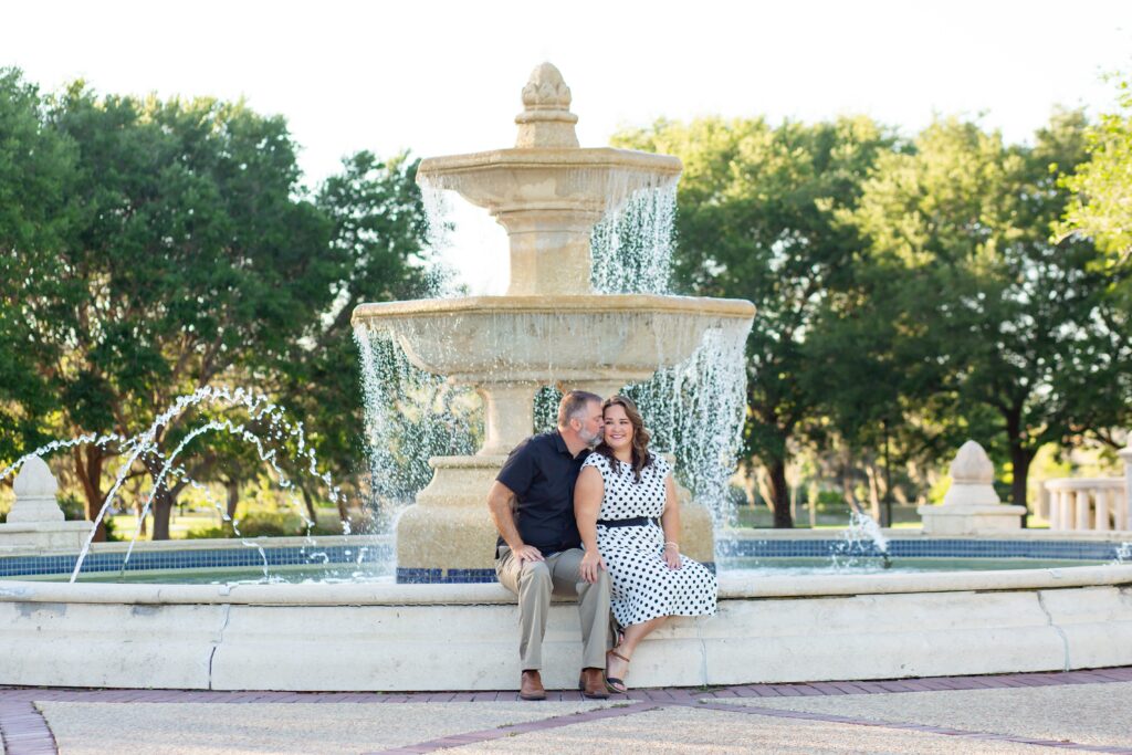 Couple sitting in front of large fountain at Blue Jacket Park for their Orlando Date Night