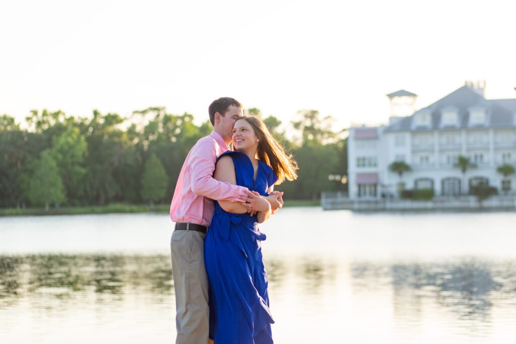 Couple in front of Bohemian Hotel in Celebration Florida Orlando overlooking the water at sunset for their engagement photos