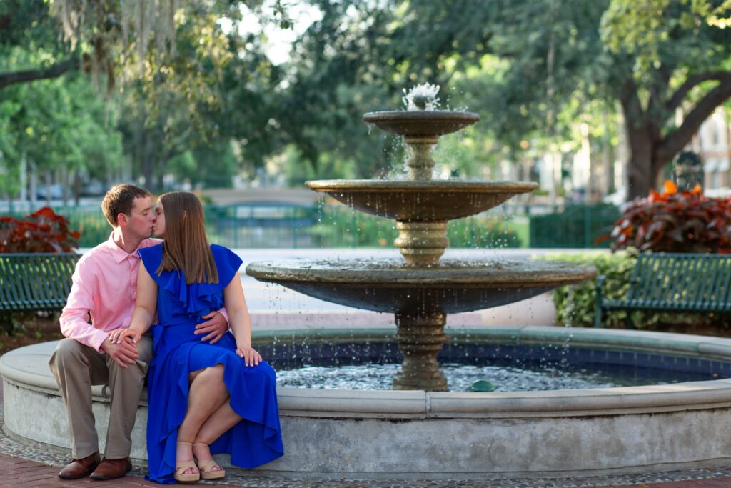 Couple kissing at fountain in Celebration Florida Orlando for their engagement photos