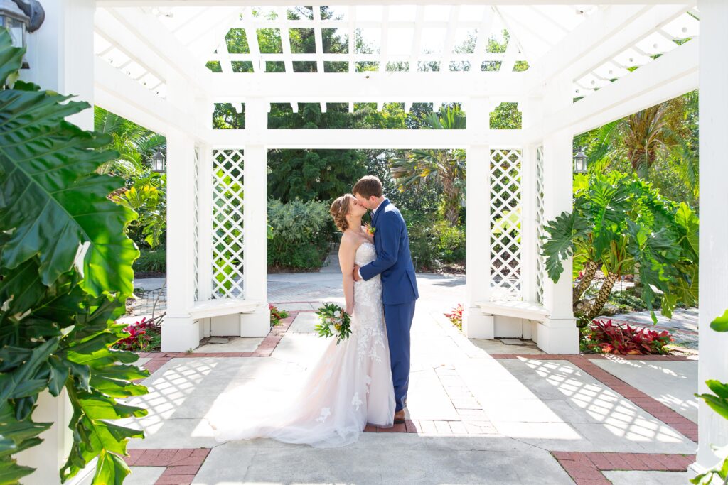 Bride and Groom kissing under the gazebo at the idea garden at Leu Gardens Orlando after their elopement