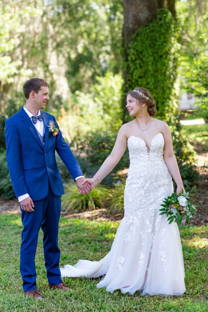 Bride and Groom holding hands and walking at Leu Gardens Orlando after their elopement