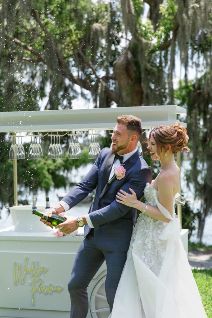 Bride and Groom popping Champagne at Rollins College in Winter Park Florida after their elopement