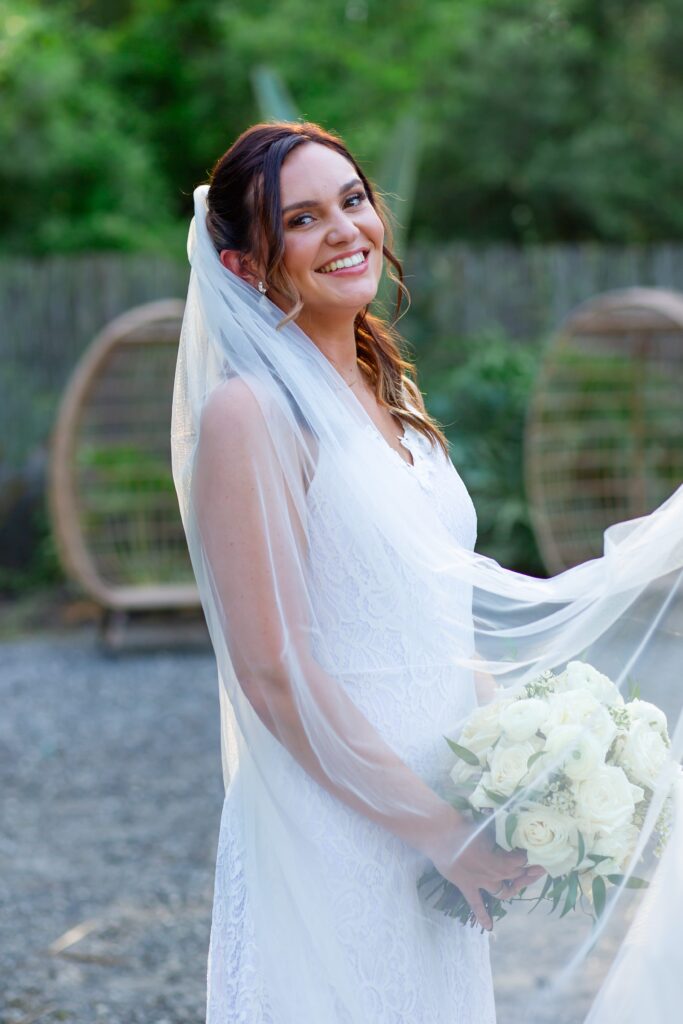 Bride holding ivory bridal bouquet under veil at the Pinery wedding venue in Florida