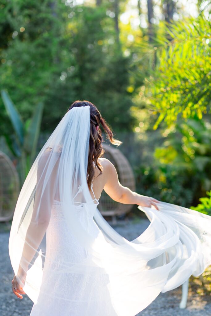 Bride twirling veil at sunset at the Pinery wedding venue in Florida