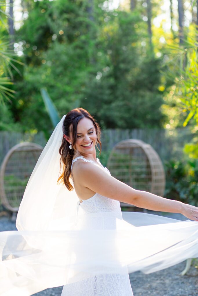 Bride twirling veil at sunset at the Pinery wedding venue in Florida