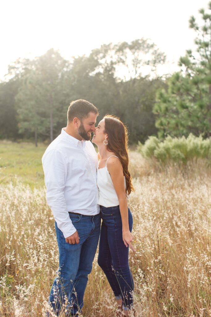 Couple laughing standing in field for their sunset engagement photos at Lake Louisa State Park in Orlando Florida